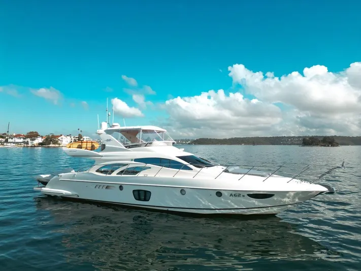 Azimut 62 Evolution Yacht Photos Pics 2007 Azimut 62 Evolution yacht on calm water under a clear blue sky.