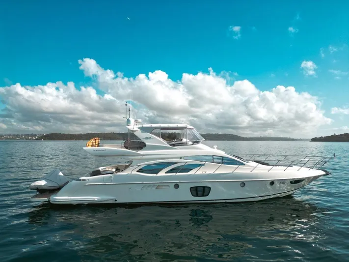 Azimut 62 Evolution Yacht Photos Pics 2007 Azimut 62 Evolution yacht on calm water under a bright blue sky.