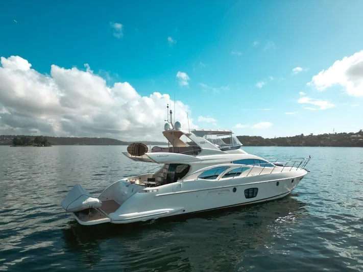 Azimut 62 Evolution Yacht Photos Pics 2007 Azimut 62 Evolution yacht on calm waters under a clear blue sky.