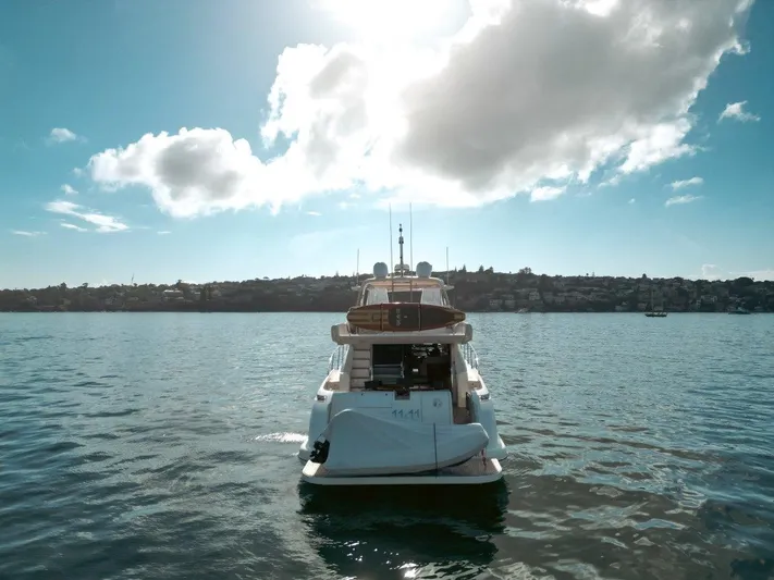 Azimut 62 Evolution Yacht Photos Pics 2007 Azimut 62 Evolution yacht on serene water under a bright sky.