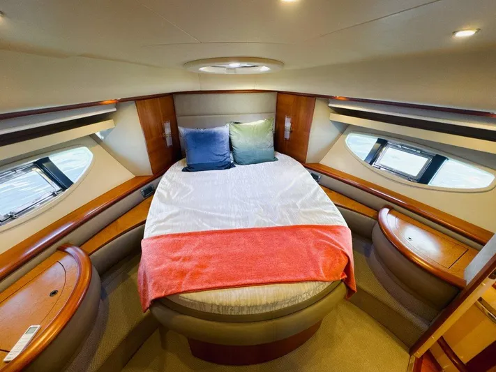 Azimut 62 Evolution Yacht Photos Pics Luxurious bedroom interior of 2007 Azimut 62 Evolution yacht with cozy bed and elegant wood finish.