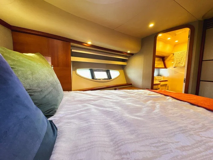 Azimut 62 Evolution Yacht Photos Pics Luxurious bedroom interior of 2007 Azimut 62 Evolution yacht with elegant bedding and ambient lighting.