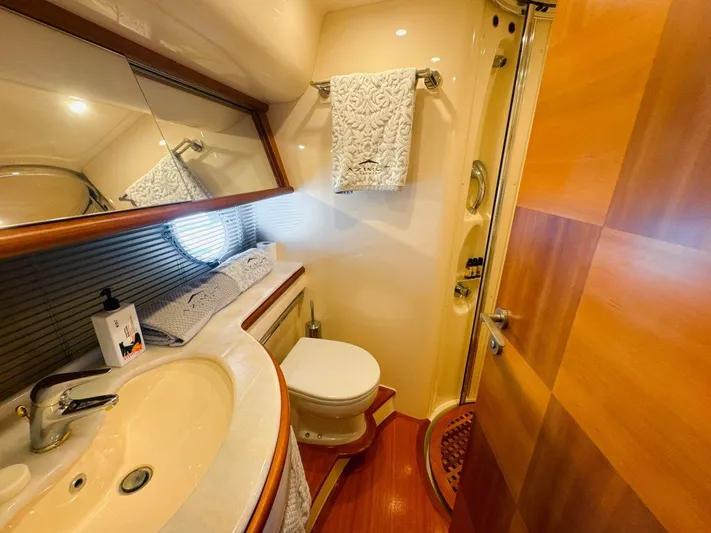 Azimut 62 Evolution Yacht Photos Pics Luxurious bathroom in 2007 Azimut 62 Evolution yacht with elegant fixtures and wooden accents.