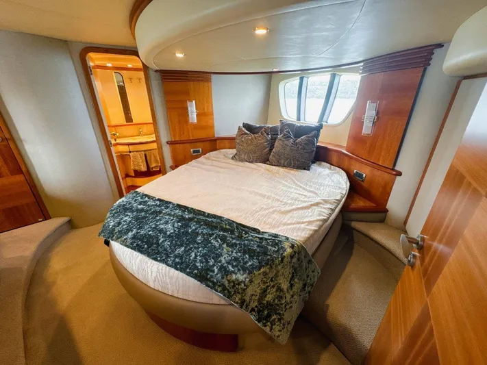Azimut 62 Evolution Yacht Photos Pics Luxurious bedroom interior of 2007 Azimut 62 Evolution yacht with elegant wood finishes.