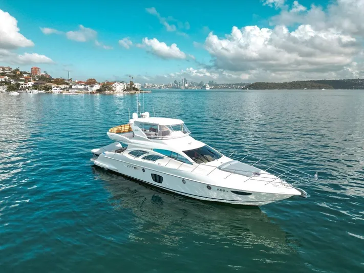 Azimut 62 Evolution Yacht Photos Pics Luxurious 2007 Azimut 62 Evolution yacht cruising on serene blue waters under a partly cloudy sky.