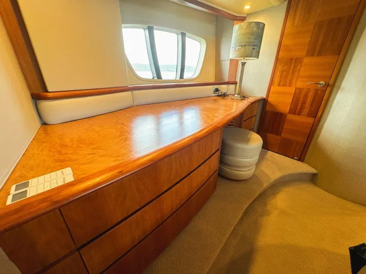 Azimut 62 Evolution Yacht Photos Pics Luxurious interior of 2007 Azimut 62 Evolution yacht with wooden desk and porthole windows.