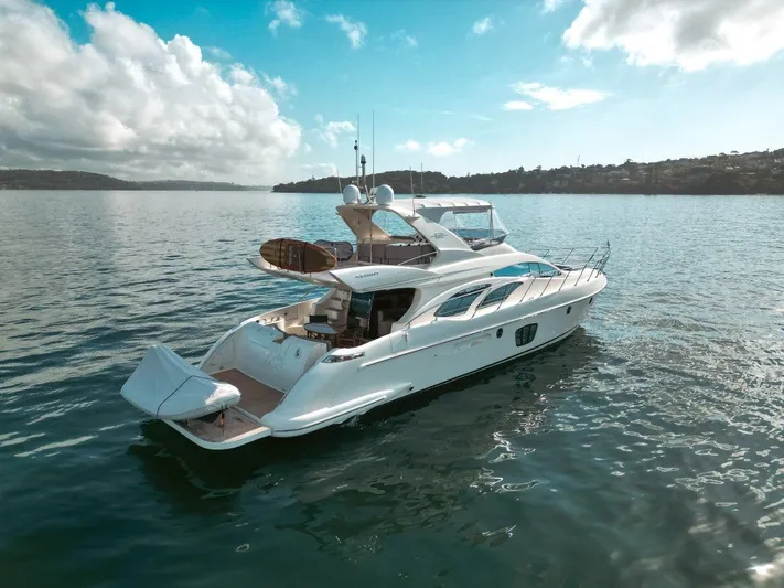 Azimut 62 Evolution Yacht Photos Pics 2007 Azimut 62 Evolution yacht on calm water under a partly cloudy sky.