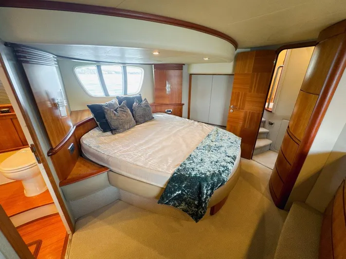 Azimut 62 Evolution Yacht Photos Pics Luxurious bedroom interior of 2007 Azimut 62 Evolution yacht with elegant wood finishes.