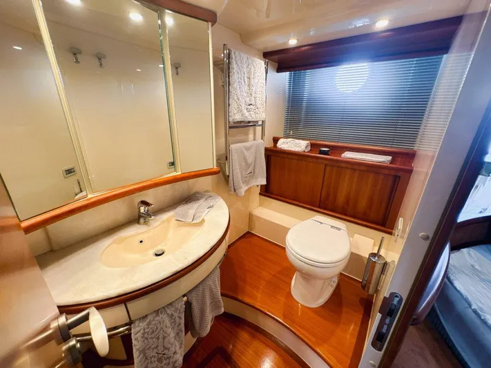 Azimut 62 Evolution Yacht Photos Pics Luxurious bathroom in 2007 Azimut 62 Evolution yacht with modern fixtures and wooden accents.
