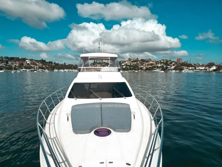 Azimut 62 Evolution Yacht Photos Pics 2007 Azimut 62 Evolution yacht on calm water under a blue sky with clouds.