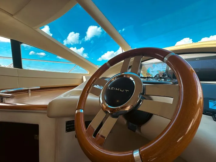 Azimut 62 Evolution Yacht Photos Pics Steering wheel of 2007 Azimut 62 Evolution yacht under a clear blue sky.