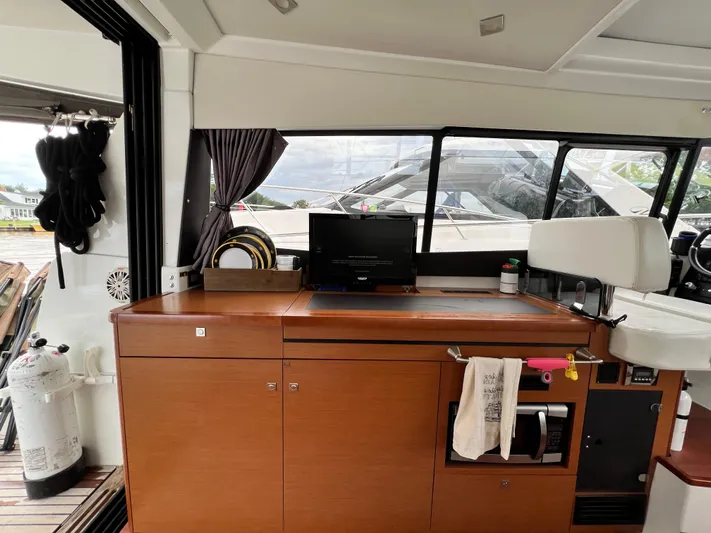  Yacht Photos Pics Interior of a 2017 Jeanneau NC11 yacht with wooden cabinetry and modern amenities.