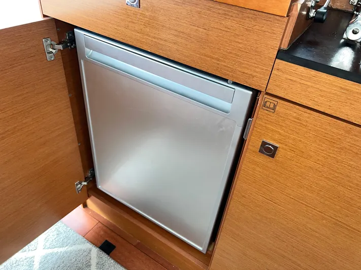  Yacht Photos Pics Built-in refrigerator in 2017 Jeanneau NC11 yacht's wooden cabinetry.