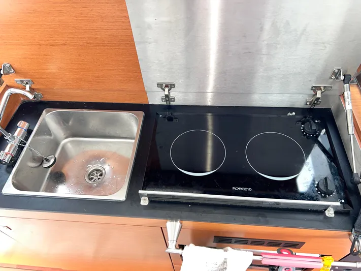  Yacht Photos Pics Kitchen area of 2017 Jeanneau NC11 with sink and electric stove.