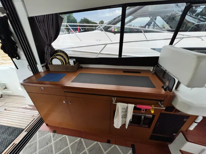  Yacht Photos Pics Interior of 2017 Jeanneau NC11 yacht with wooden cabinetry and modern design.
