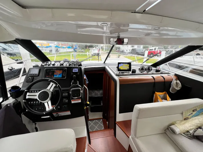  Yacht Photos Pics Interior view of 2017 Jeanneau NC11 boat cockpit with navigation equipment.