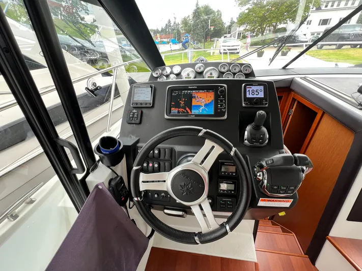  Yacht Photos Pics 2017 Jeanneau NC11 helm with navigation controls and digital displays.