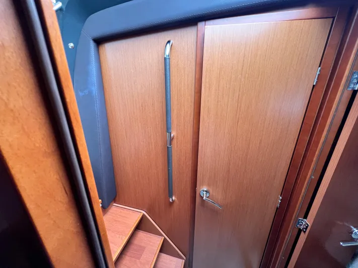  Yacht Photos Pics 2017 Jeanneau NC11 interior with wooden door and steps.