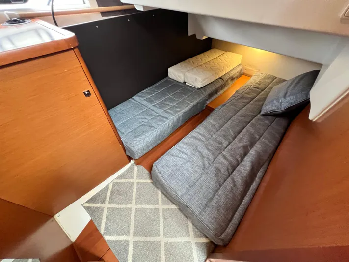  Yacht Photos Pics 2017 Jeanneau NC11 cabin interior with twin beds and wooden finish.