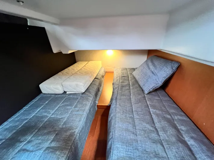  Yacht Photos Pics Cozy cabin interior of 2017 Jeanneau NC11 with twin beds and soft lighting.