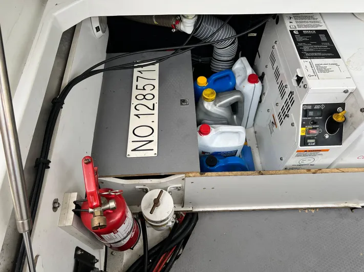  Yacht Photos Pics Engine compartment of a 2017 Jeanneau NC11 with fire extinguisher and maintenance supplies.