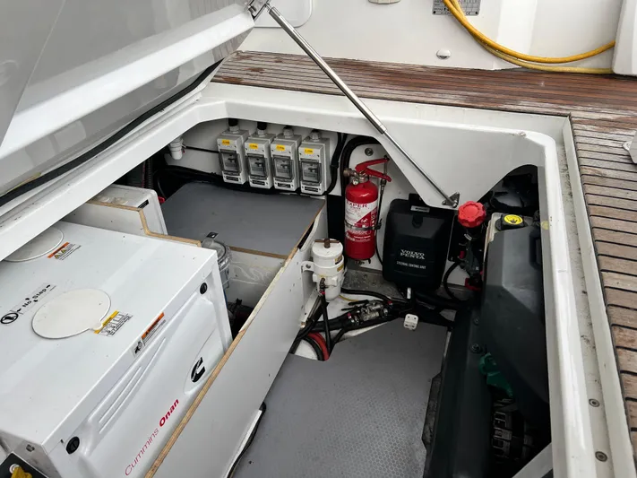  Yacht Photos Pics Engine compartment of 2017 Jeanneau NC11 boat with equipment and fire extinguisher.