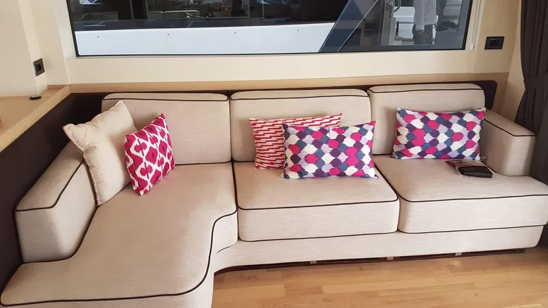  Yacht Photos Pics Beige sofa with colorful geometric pillows on a Sirena 64 yacht, 2018 model.