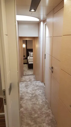  Yacht Photos Pics Luxurious hallway interior of 2018 Sirena 64 yacht, featuring plush carpeting and modern design.