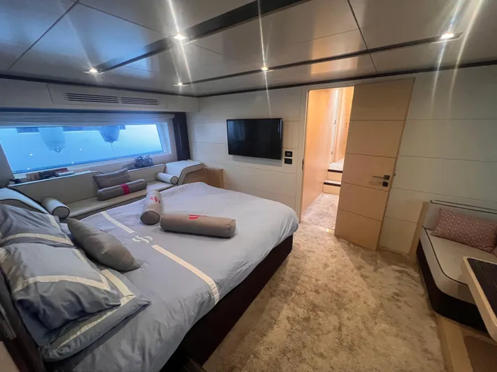  Yacht Photos Pics Luxurious bedroom interior of 2018 Sirena 64 yacht with modern decor and large window view.
