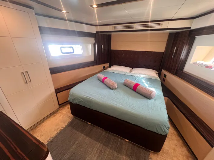  Yacht Photos Pics Luxurious bedroom interior of 2018 Sirena 64 yacht with modern design and cozy bedding.