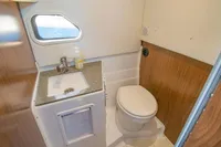 2021 Four Winns Vista 255 bathroom with sink, toilet, and window.