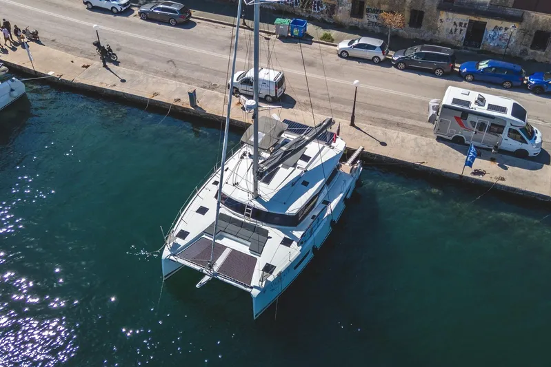  Yacht Photos Pics Aerial view of 2023 Fountaine Pajot Astrea 42 Maestro catamaran docked at a marina.