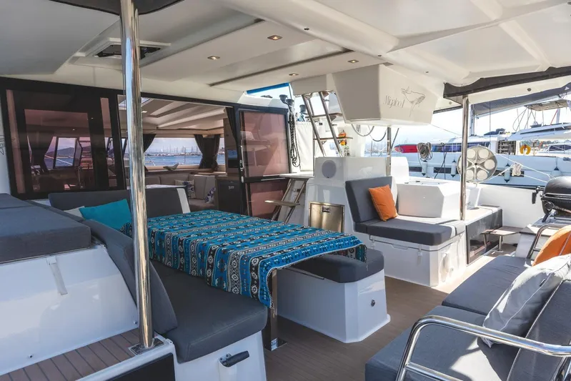  Yacht Photos Pics Luxurious 2023 Fountaine Pajot Astrea 42 Maestro yacht interior with modern seating and vibrant decor.
