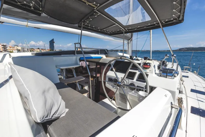  Yacht Photos Pics 2023 Fountaine Pajot Astrea 42 Maestro yacht cockpit with steering wheel and ocean view.