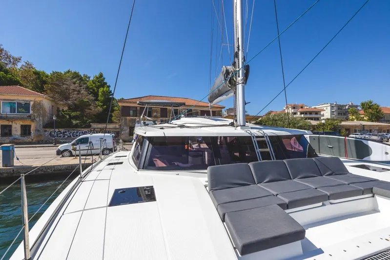  Yacht Photos Pics 2023 Fountaine Pajot Astrea 42 Maestro catamaran docked, featuring spacious deck and modern design.