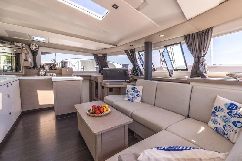  Yacht Photos Pics Luxurious interior of 2023 Fountaine Pajot Astrea 42 Maestro catamaran with modern kitchen and seating.