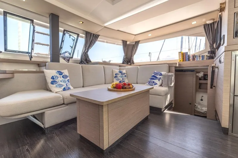  Yacht Photos Pics Luxurious interior of 2023 Fountaine Pajot Astrea 42 Maestro catamaran with modern seating and decor.
