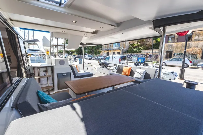  Yacht Photos Pics 2023 Fountaine Pajot Astrea 42 Maestro yacht interior with modern seating and table.