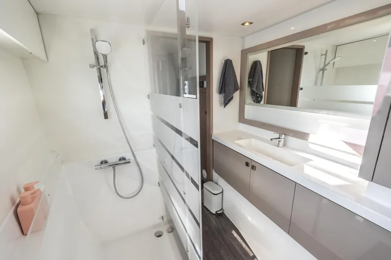  Yacht Photos Pics Luxurious bathroom in 2023 Fountaine Pajot Astrea 42 Maestro catamaran, featuring modern fixtures and sleek design.