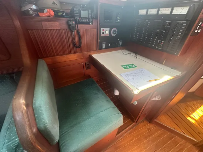 Hawk Yacht Photos Pics Navigation station inside 1987 Sabre 42 sailboat with control panels and seating.
