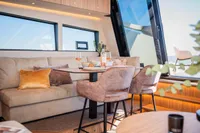 Luxurious interior of 2025 Super Lauwersmeer SLX54 yacht with elegant seating and dining area.