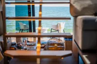 Luxurious Super Lauwersmeer SLX54 yacht interior with ocean view, featuring elegant dining setup, 2025 model.