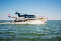 2025 Super Lauwersmeer SLX54 yacht cruising on open water under clear blue skies.