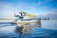 2025 Super Lauwersmeer SLX54 yacht cruising on calm waters under a clear blue sky.