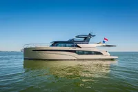 2025 Super Lauwersmeer SLX54 yacht on calm water under clear blue sky.