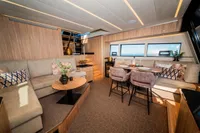 Luxurious interior of 2025 Super Lauwersmeer SLX54 yacht with modern seating and dining area.