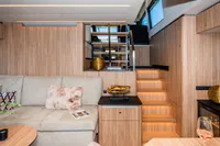 Luxurious interior of 2025 Super Lauwersmeer SLX54 yacht with modern wood finish and cozy seating.