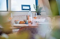 Luxurious dining setup on Super Lauwersmeer SLX54 yacht, featuring wine and elegant tableware.