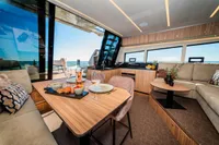Luxurious interior of 2025 Super Lauwersmeer SLX54 yacht with elegant dining area and scenic ocean view.