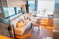 Luxurious interior of 2025 Super Lauwersmeer SLX54 yacht with elegant dining area and sea view.